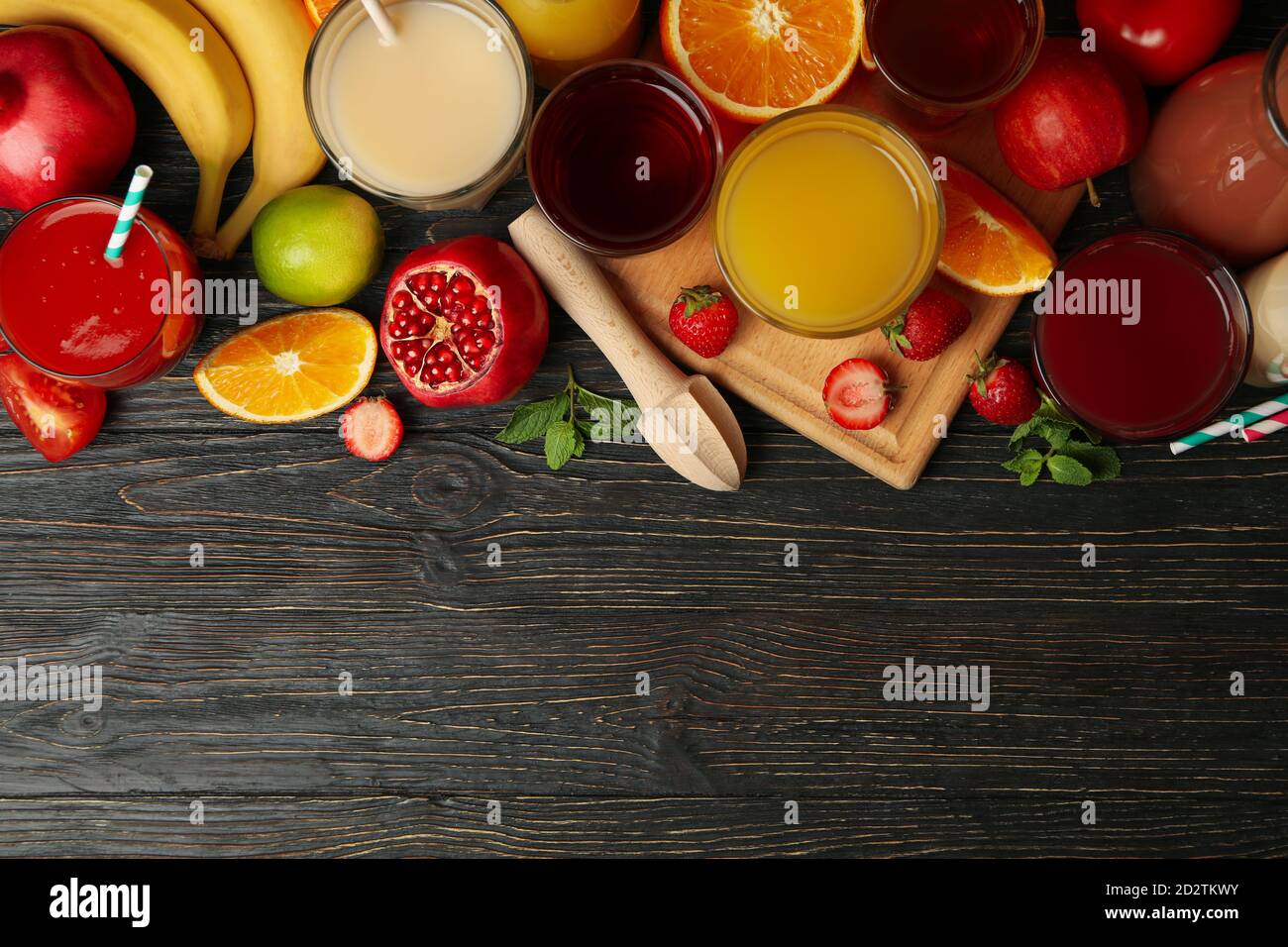 Glasses and jars with different juices on wooden background Stock Photo