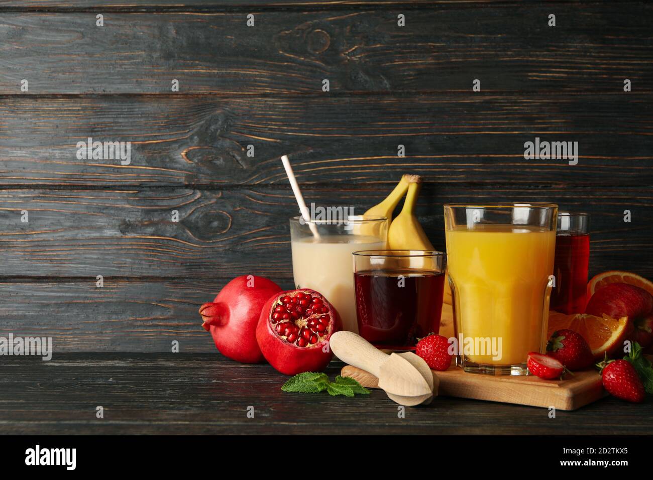 Glasses and jars with different juices on wooden background Stock Photo