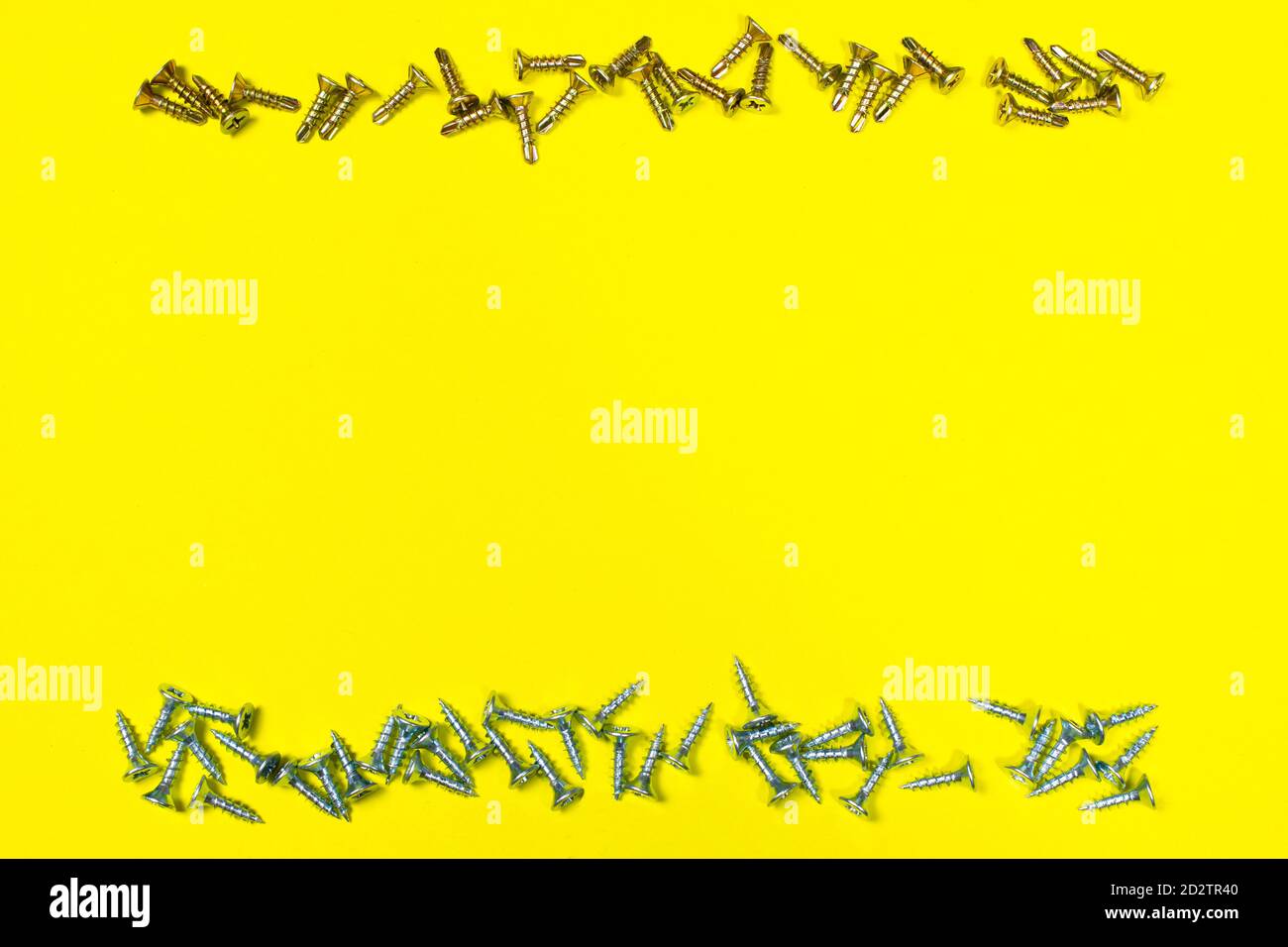 Self-cutters on wood and metal on a yellow background with space for text. Banner for construction shop, repairs and fittings. Stock Photo