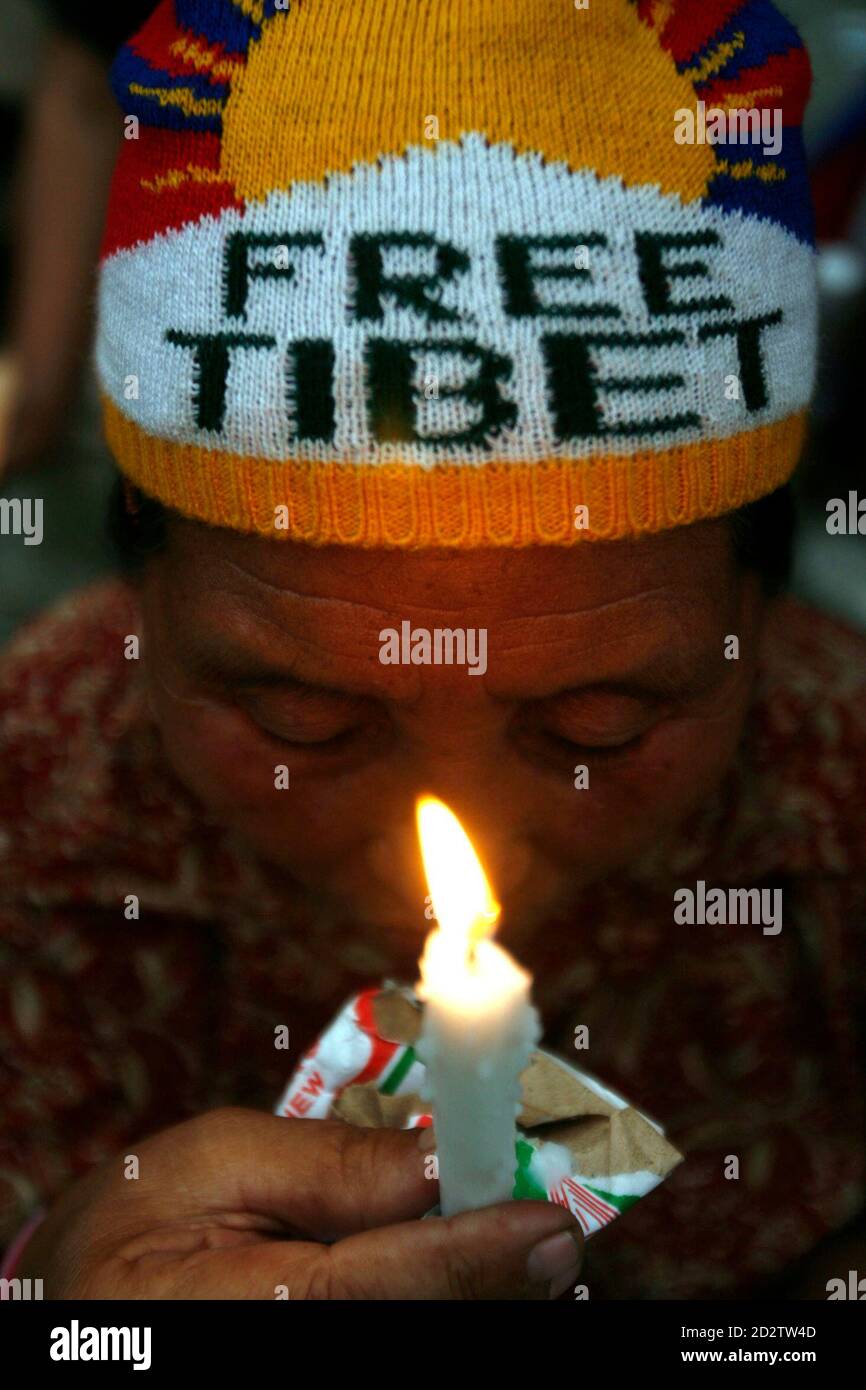 A Tibetan refugee takes part in a candle light vigil, after Indian police stopped a peace rally on its way to the Indo-China border at Nathula, at Rangopo village, about 80 km (50 miles) north of the northeastern Indian city of Siliguri March 24, 2008. REUTERS/Rupak De Chowdhuri (INDIA) Stock Photo