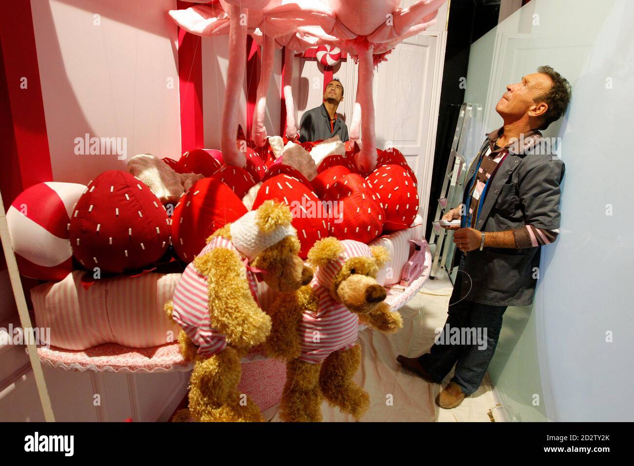 Frenchman Jean-Claude Dehix (R), the head puppeteer for Paris department  stores, prepares stuffed animals whose movements are controlled by strings  and motors, for a Christmas storefront window display on October 28, 2008.