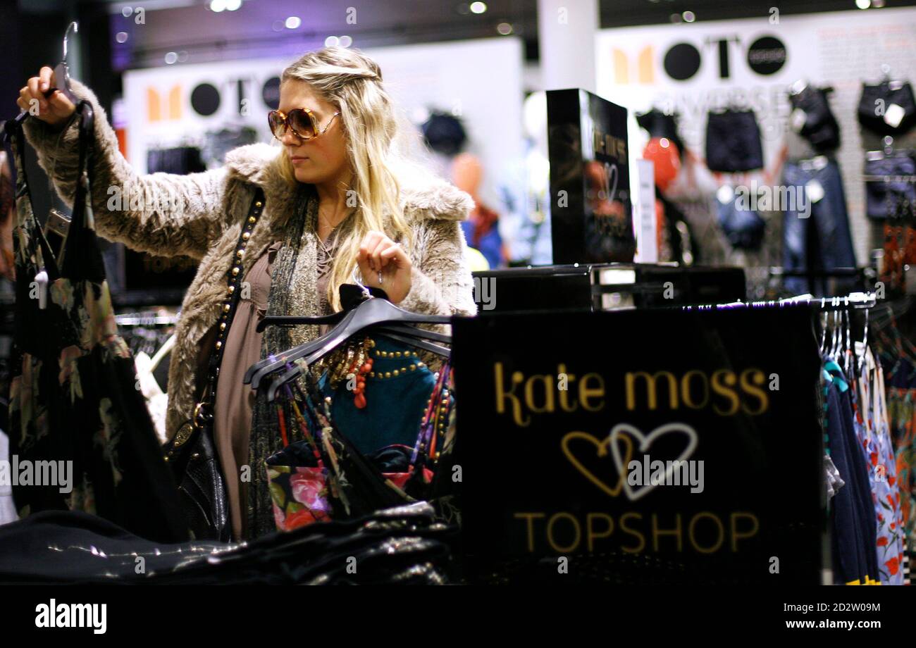 A woman looks at clothing items while shopping in the new Topshop and  Topman clothing store in New York April 2, 2009. Topshop, Britain's trendy  mass-market fashion retailer, could eventually have about