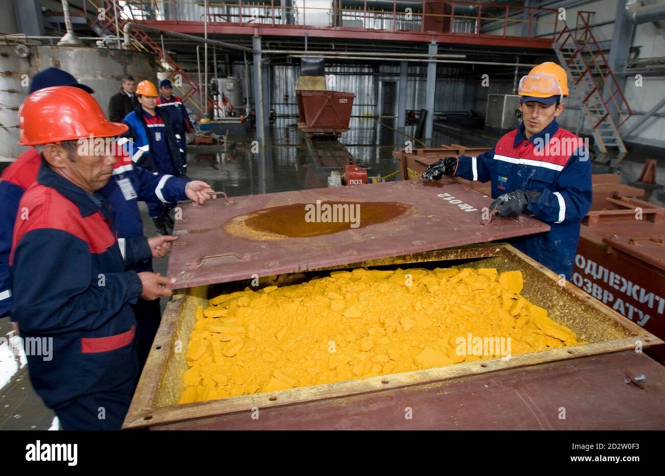 Workers close a container of uranium oxide after the opening of the Khorasan-1 uranium mine in southern Kazakhstan April 24, 2009. Japan opened the major uranium mine in Kazakhstan on Friday, gaining access to alternative energy supplies from resource-rich Central Asia.   REUTERS/Shamil Zhumatov (KAZAKHSTAN POLITICS ENERGY) Stock Photo