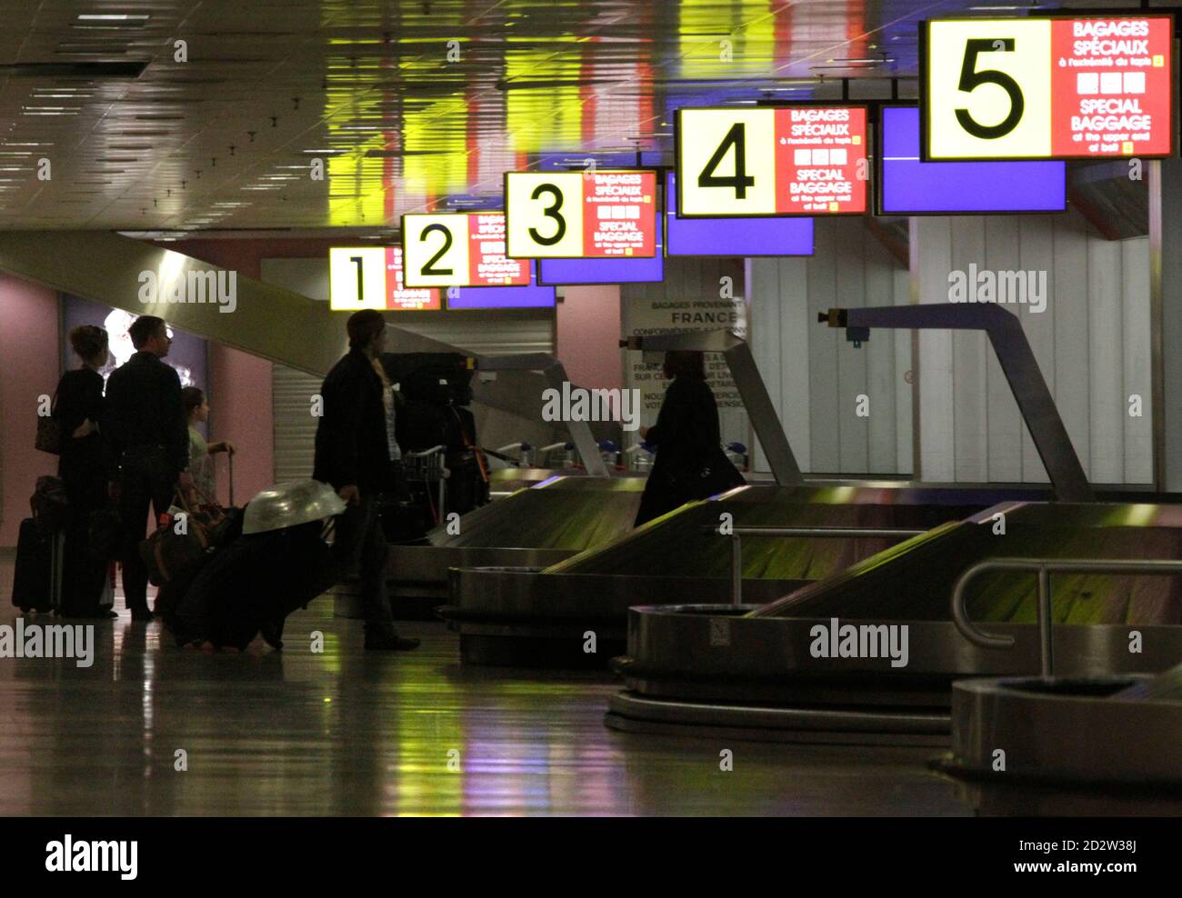 Passengers collect their luggage after their arrival at Cointrin airport in  Geneva April 20, 2010. Switzerland's civil aviation authority has decided  to reopen Swiss air space from 0600 GMT on Tuesday following