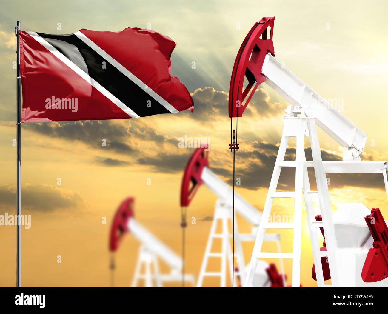 Oil rigs against the backdrop of the colorful sky and a flagpole with