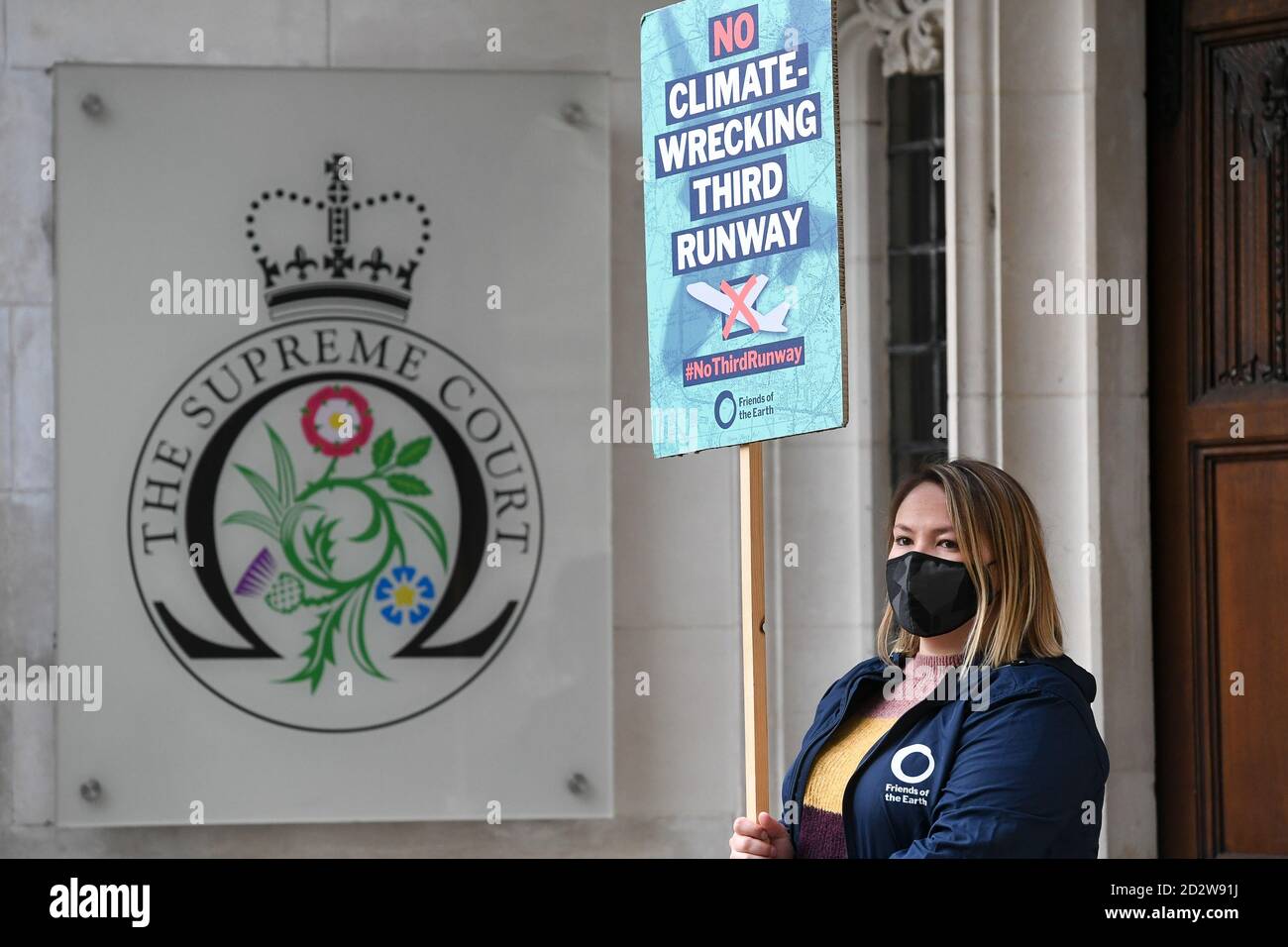 Demonstrators against a third Heathrow runway gather outside the Royal Courts of Justice, London, where a panel of five Supreme Court justices are due to determine whether the decision to support the expansion of Heathrow Airport was unlawful. Stock Photo