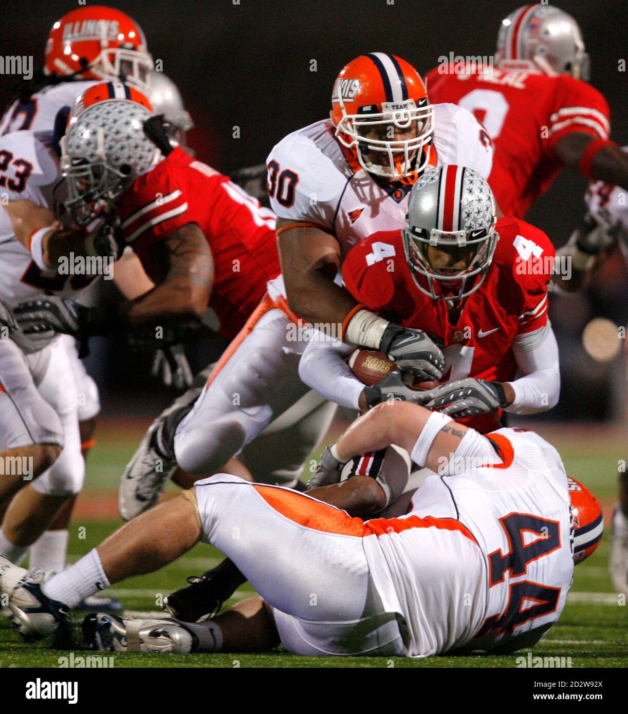 Ohio State University Wide Receiver Ray Small 4 Is Tackled For A Loss By University Of Illinois Defenders Mike Locksley Jr 30 And Brit Miller 44 During The Third Quarter Of Their Ohio State University Wide Receiver Ray Small 4 Is Tackled For A Loss By University Of Illinois Defenders Mike Locksley Jr 30 And Brit Miller 44 During The Third Quarter Of Their