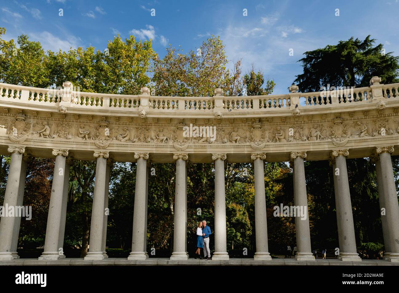 Remote view of couple embracing each other standing on stone columns of ...