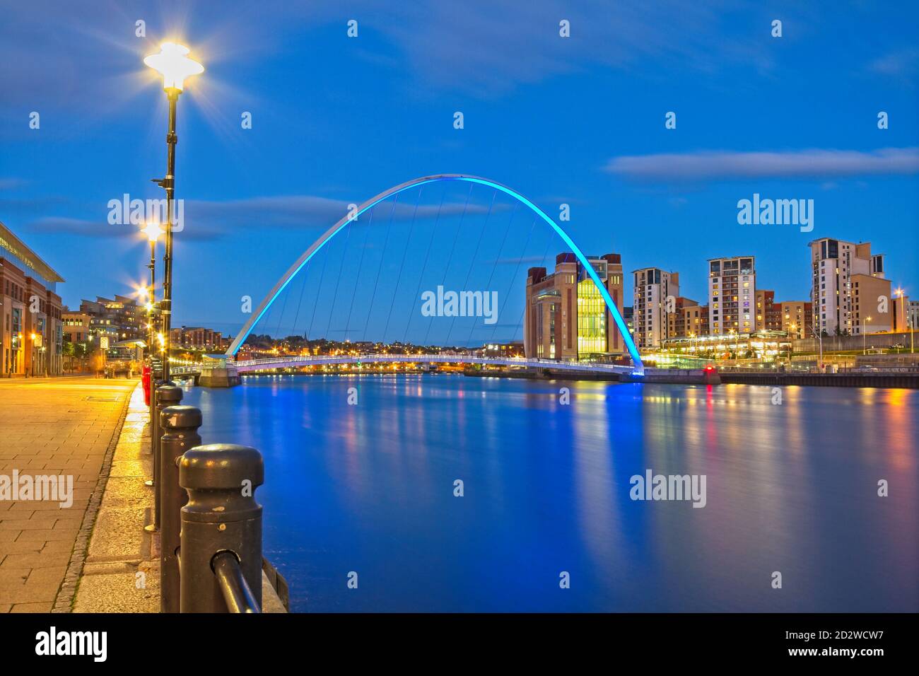 A view looking down the River Tyne at dusk from Newcastle's quayside towards the Gateshead Millennium Bridge, Baltic Arts Centre and Gateshead Quays. Stock Photo