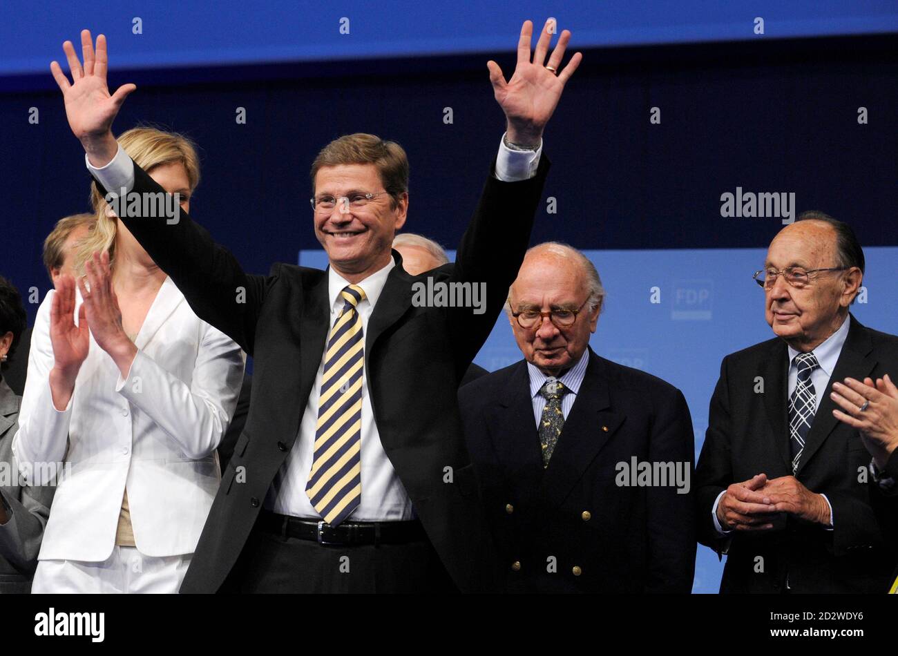 Guido Westerwelle, party leader of Germany's liberal Free Democratic Party (FDP) acknowledges applause following his key-note speech at a three-day FDP party congress in Hanover May 15, 2009. At right are former FDP leaders Otto Graf Lambsdorff and Hans-Dietrich Genscher (far R).  REUTERS/Wolfgang Rattay    (GERMANY POLITICS) Stock Photo