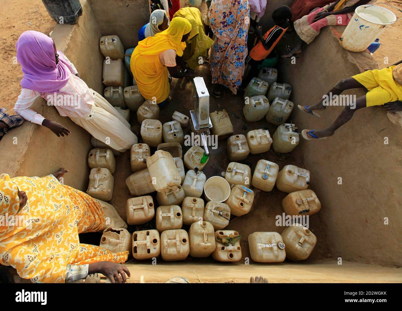 Displaced Sudanese women fill their containers at a water point in the Abu Shouk IDP (internally displaced persons) camp at Al Fasher, northern Darfur April 8, 2010. REUTERS/Zohra Bensemra (SUDAN - Tags: SOCIETY) Stock Photo