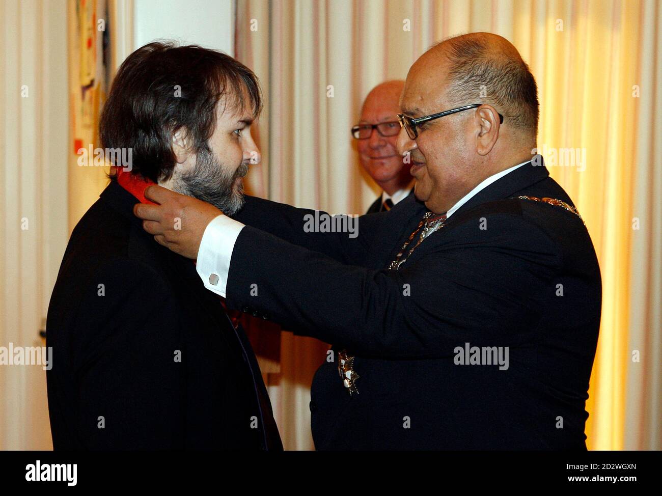 Director Peter Jackson (L) of New Zealand is knighted by New Zealand's Governor-General Anand Satyanand at Premier House in Wellington April 28, 2010. Jackson who directed the 'Lord Of The Rings' trilogy, received the Knight Companion of the New Zealand Order of Merit, for services to the arts. REUTERS/Dominion Post/ Kent Blechynden/Pool (NEW ZEALAND - Tags: ENTERTAINMENT POLITICS) Stock Photo