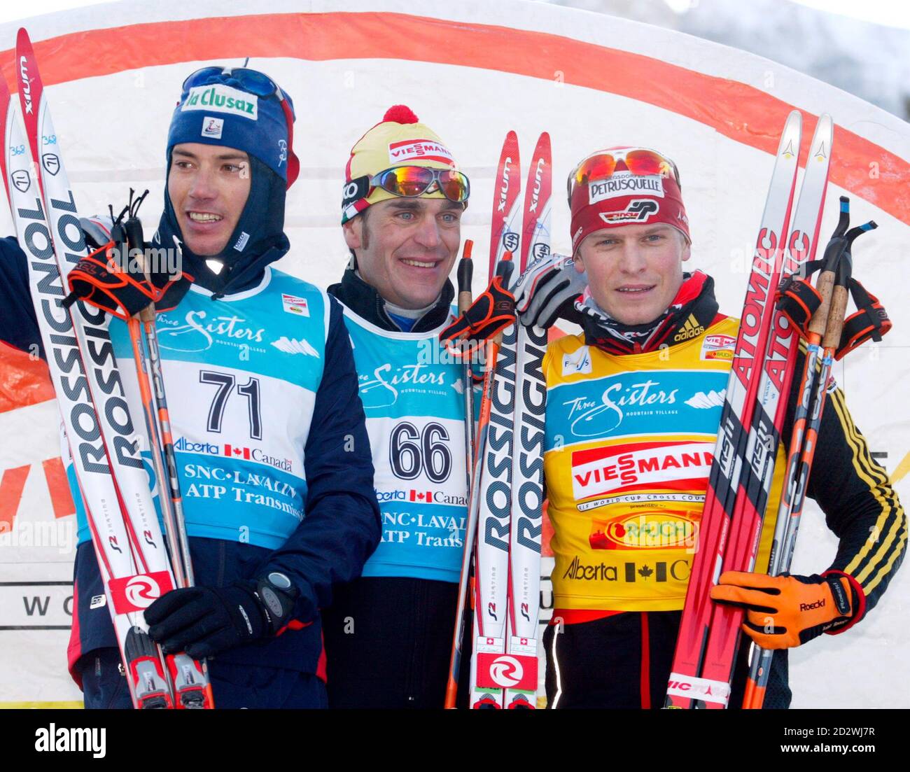 The top three winners take the podium after the men's 15km Free Individual  Cross Country Skiing World Cup in Canmore December 15, 2005. From left to  right: France's Vincent Vittoz (2nd), Italy's