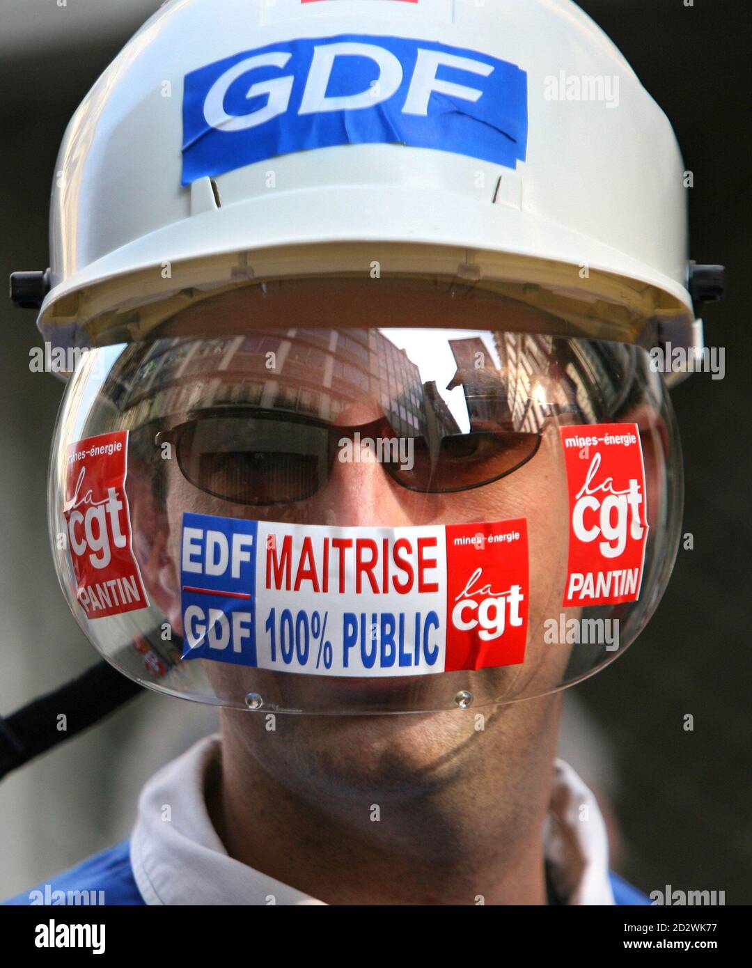 A Demonstrator Shows Off Stickers Of The French Trade Union Cgt Of Paris Energy Branch During A March Through Downtown Paris October 14 06 Hundreds Of Demonstrators Protested Against Privatisation Plans Of