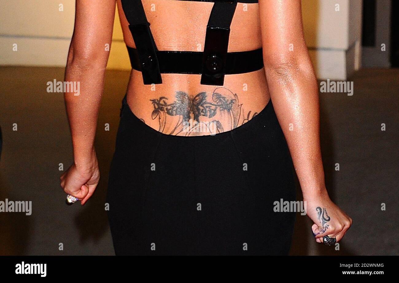 A view of the tattoo on the lower back of Cheryl Cole as she arrives for the 2011 National Television Awards at the O2 Arena, London. Stock Photo