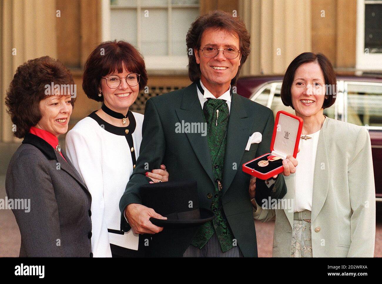 Sir Cliff Richard with his three sisters (l/r) Donna Gordon, Joan Pilgrim and Jacqui Harrison, at Buckingham Palace today (WED), after he received his Knighthood from the Queen.  Stock Photo