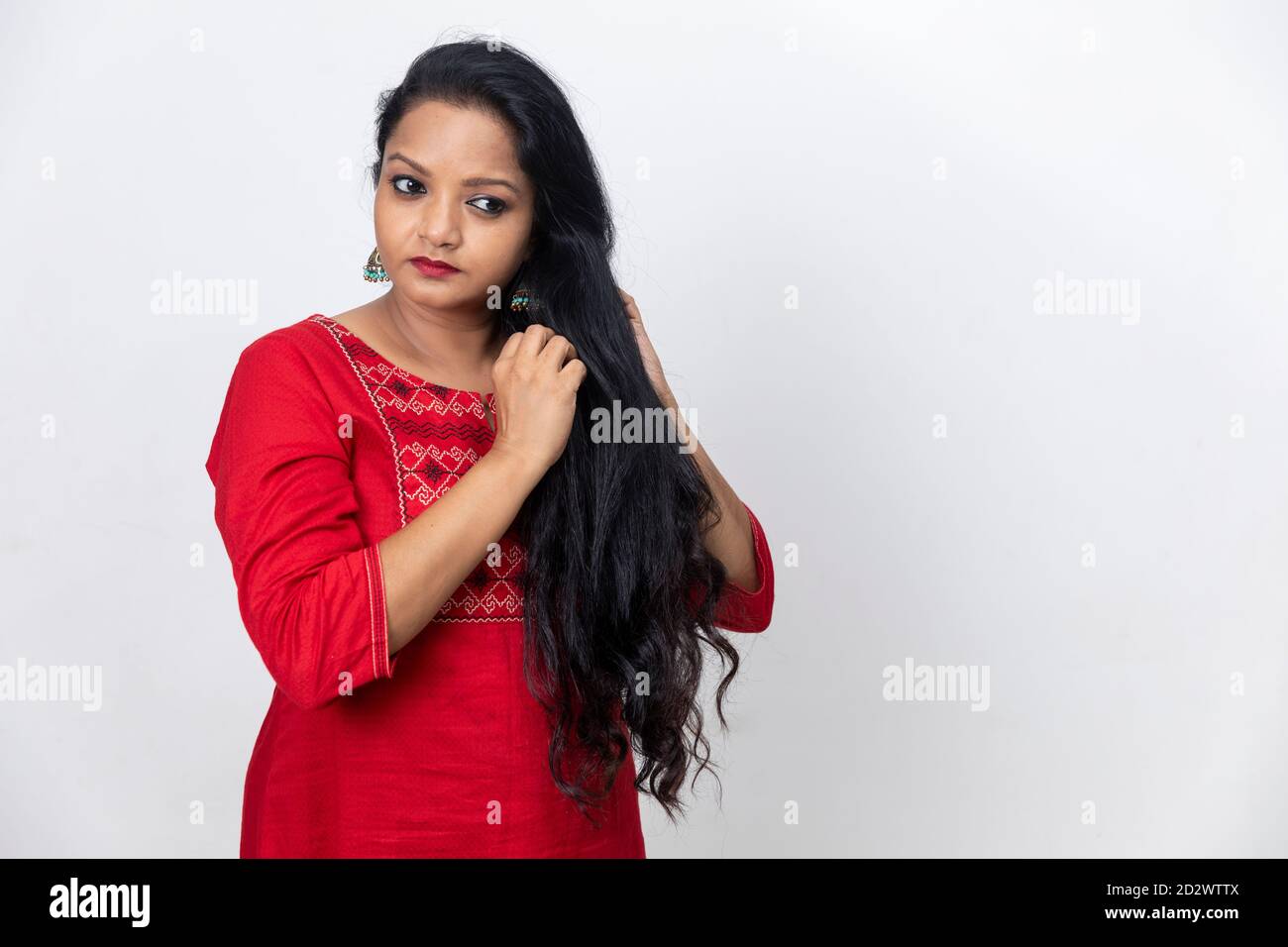 Portrait of Indian woman with fingers in her long hair, dark hair, white backdrop, indoor studio shot, copy space area Stock Photo - Alamy Portrait of Indian woman with fingers in her long hair, dark hair, white backdrop, indoor studio shot, copy space area Stock Photo - Alamy