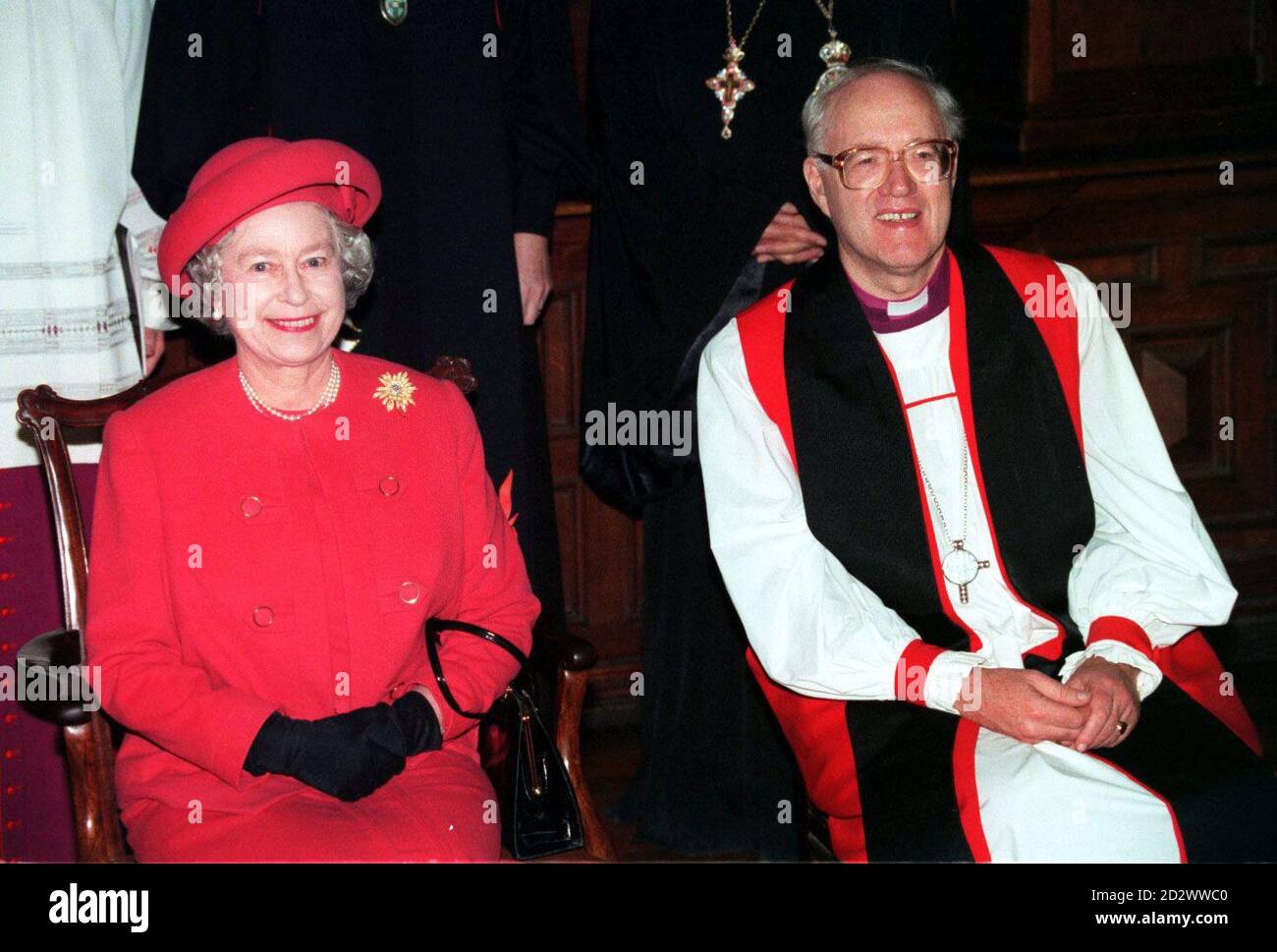 Her Majesty The Queen sits with the Archbishop of Canterbury Dr George Carey during an ecumenical service at Westminster Cathedral in London today (Thursday). The service, which made history as it was the first time The Queen had ever attended a full service in a Roman Catholic church, attracted the attention of a small minority of Protestant hecklers. See PA Story ROYAL Cathedral. TIMES ROTA PICTURE Stock Photo