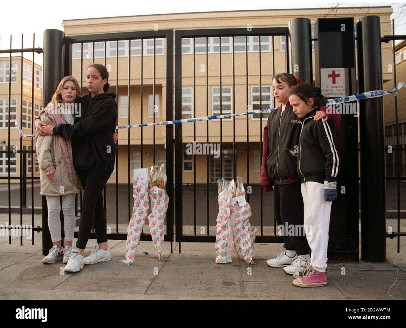 Shocked children gather outside the gates of St George's school in ...