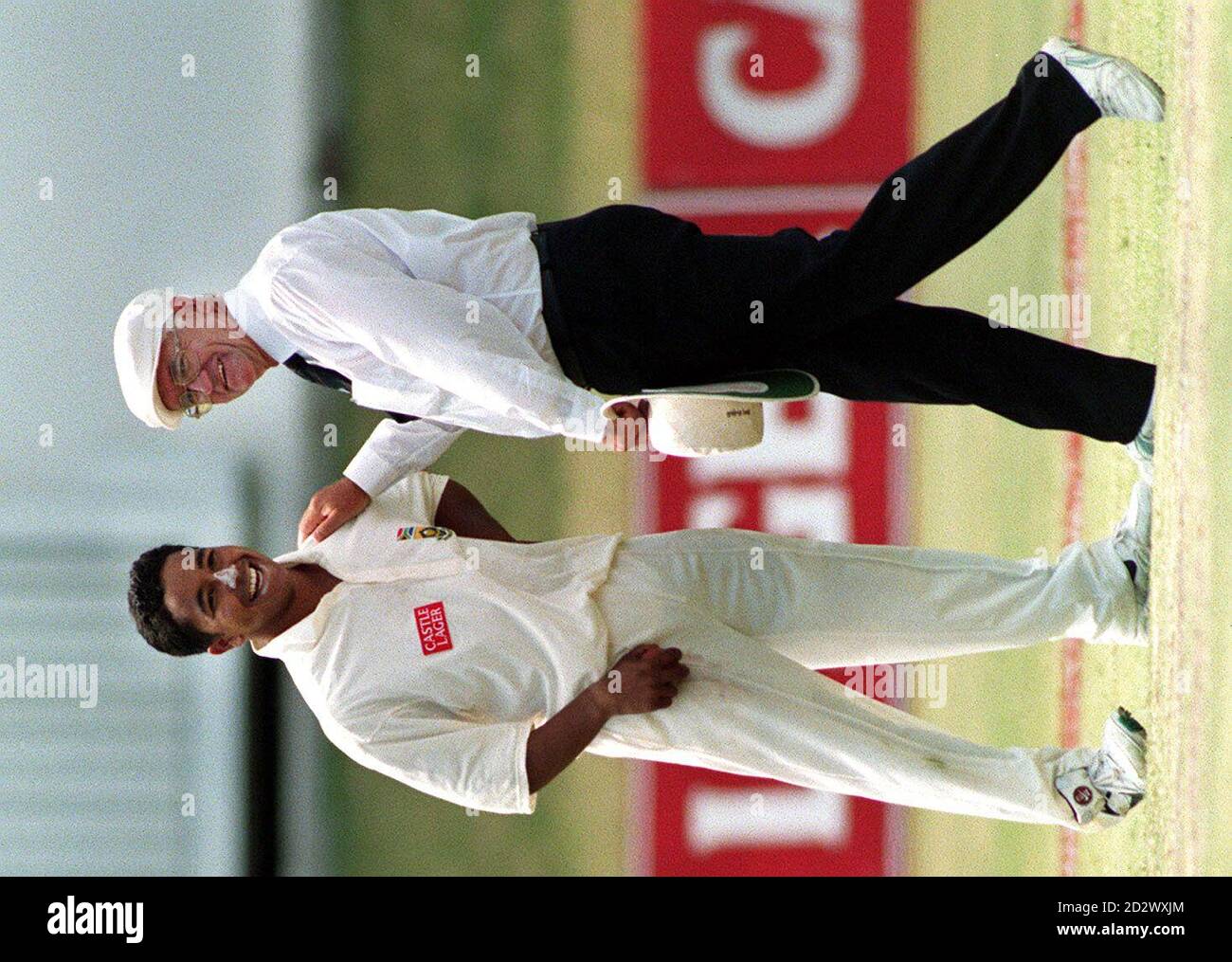 Umpire Cyril Mitchley puts an arm on the shoulder of South African spin