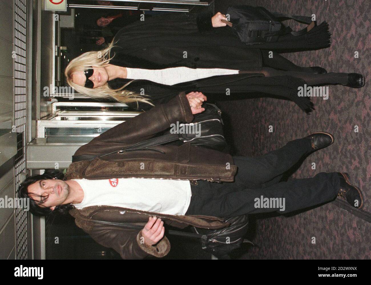 'Baywatch' star Pamela Anderson with her husband Tommy Lee at  Heathrow Airport before departing for Los Angeles today (Tuesday), after spending Christmas and the New Year in Europe. Stock Photo