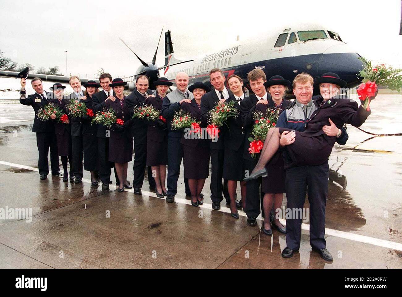 LOVE IS IN THE AIR.....British Airways couples (l-r) Captain Phil Egging with stewardess wife Linda, John and Deborah Findaly, Jonathon and Sheryl Moore, Joynal and Tracy Hague, Neil and Deborah Pritchard, Warren and Mandy Mountford, newest sweethearts John Coleman and his bride-to-be Tracy Adams, and Jason and Kay Hodgkisson. All of the British Airways couples are based at Birmingham International Airport, where 10 per cent of the 400-strong workforce are married to each other. PA. SEE PA STORY SOCIAL Valentine. Stock Photo