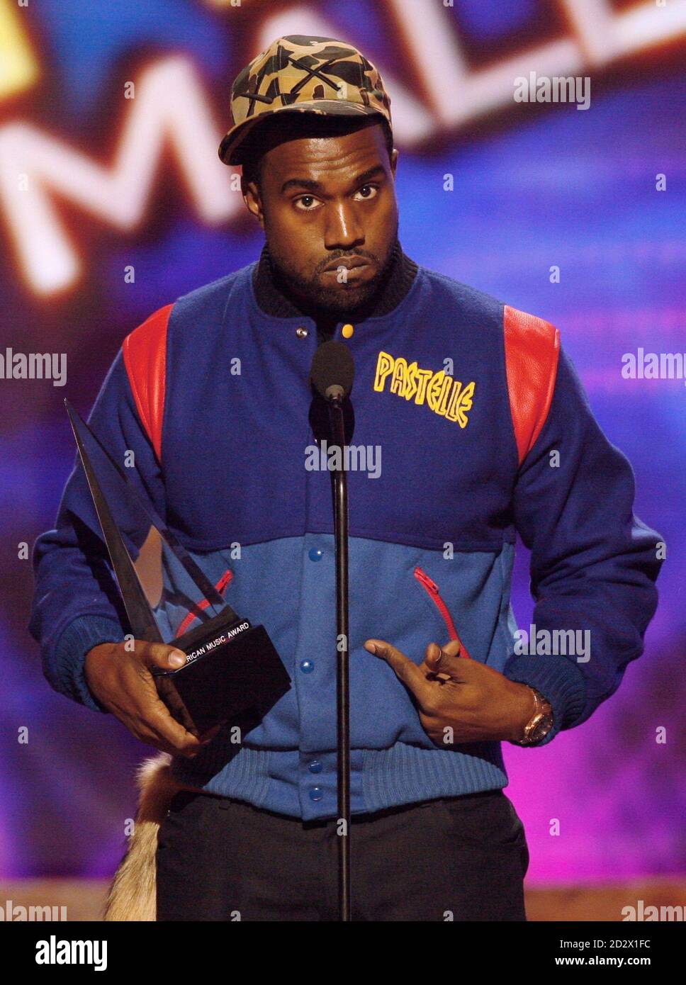 Singer Kanye West stands onstage after 