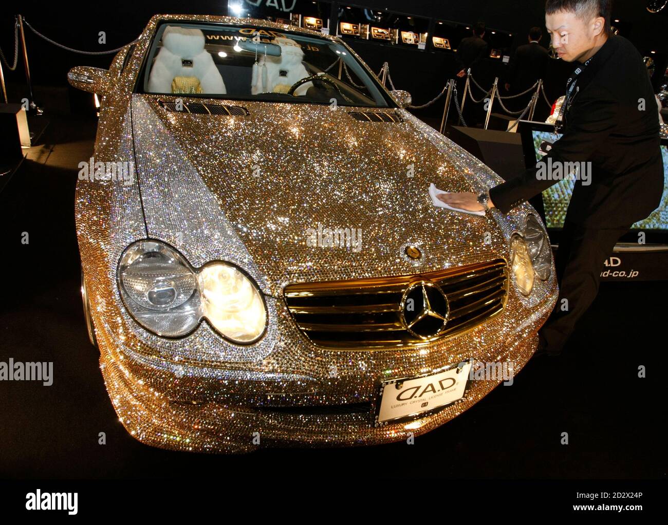 An exhibitor polishes the customized Mercedes-Benz SL600, Luxury Crystal  Benz, studded with 300,000 Swarovski crystal glass, displayed at the  pavilion of custom car accessory company Garson/D.A.D at Tokyo Auto Salon  2009 at