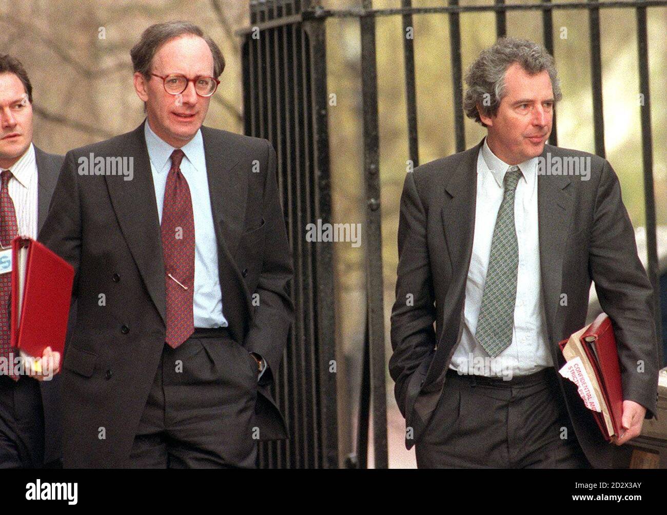 Defence Secretary Malcom Rifkind (left) and Chief Secretary to the Treasury William Waldegrave (right) arriving in Downing Street for the Cabinet Meeting.  **Man on far left un-identified** Stock Photo