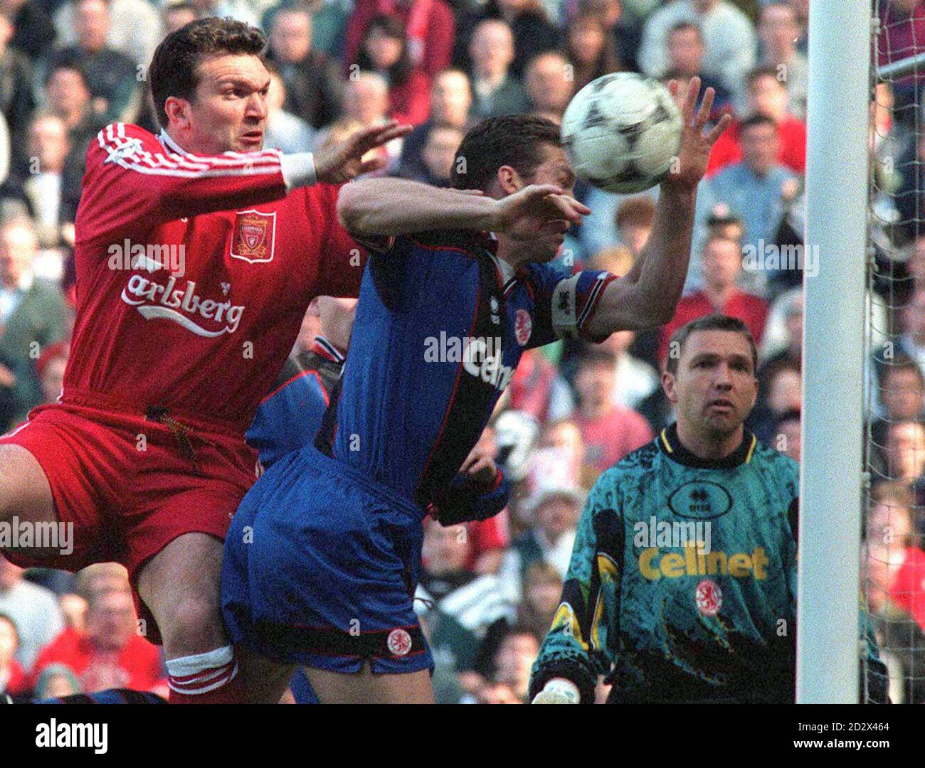 Neil Ruddock of Liverpool (left) and Pearson the Middlesbrough captain go for this cross with Pearson colliding with the upright and having to leave the match with a head injury. Stock Photo
