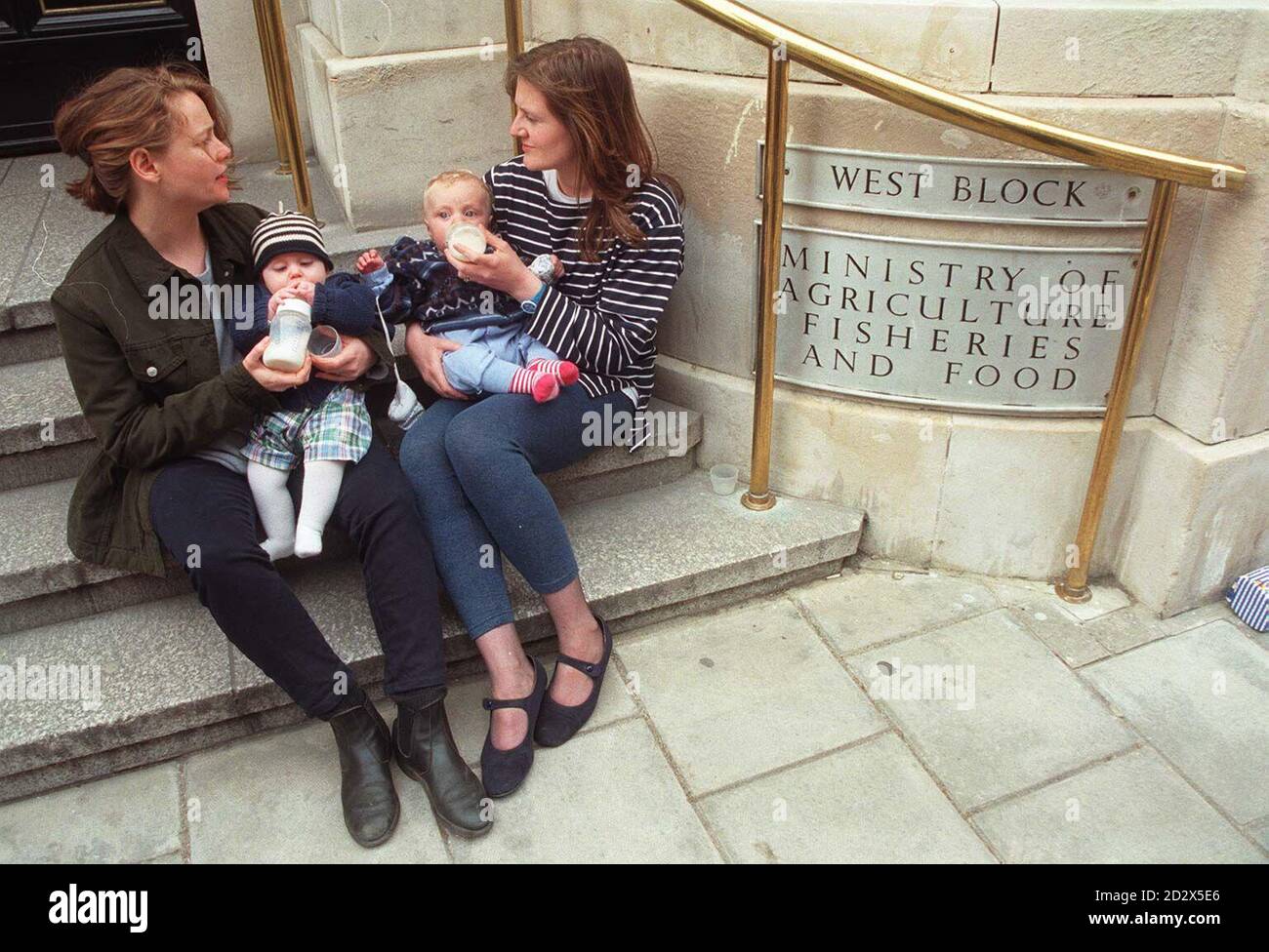 Lauren Bromley-Hodge (left), with her six-month-old daughter Hannah, and Veronica Wagner, with Ashley, seven and a half months, taking time out from a protest outside the Ministry of Agriculture Fisheries and Food today (Tuesday). The Consumers Association is today calling for a full inquiry into MAFF's handling of the baby milk scare. 14/03/03 The Government, faced serious criticisms of the way it handled the 8 billion foot-and-mouth outbreak in 2001. A report by the Commons public accounts committee said that the then Ministry of Agriculture was guilty of a serious misjudgement in assumin Stock Photo