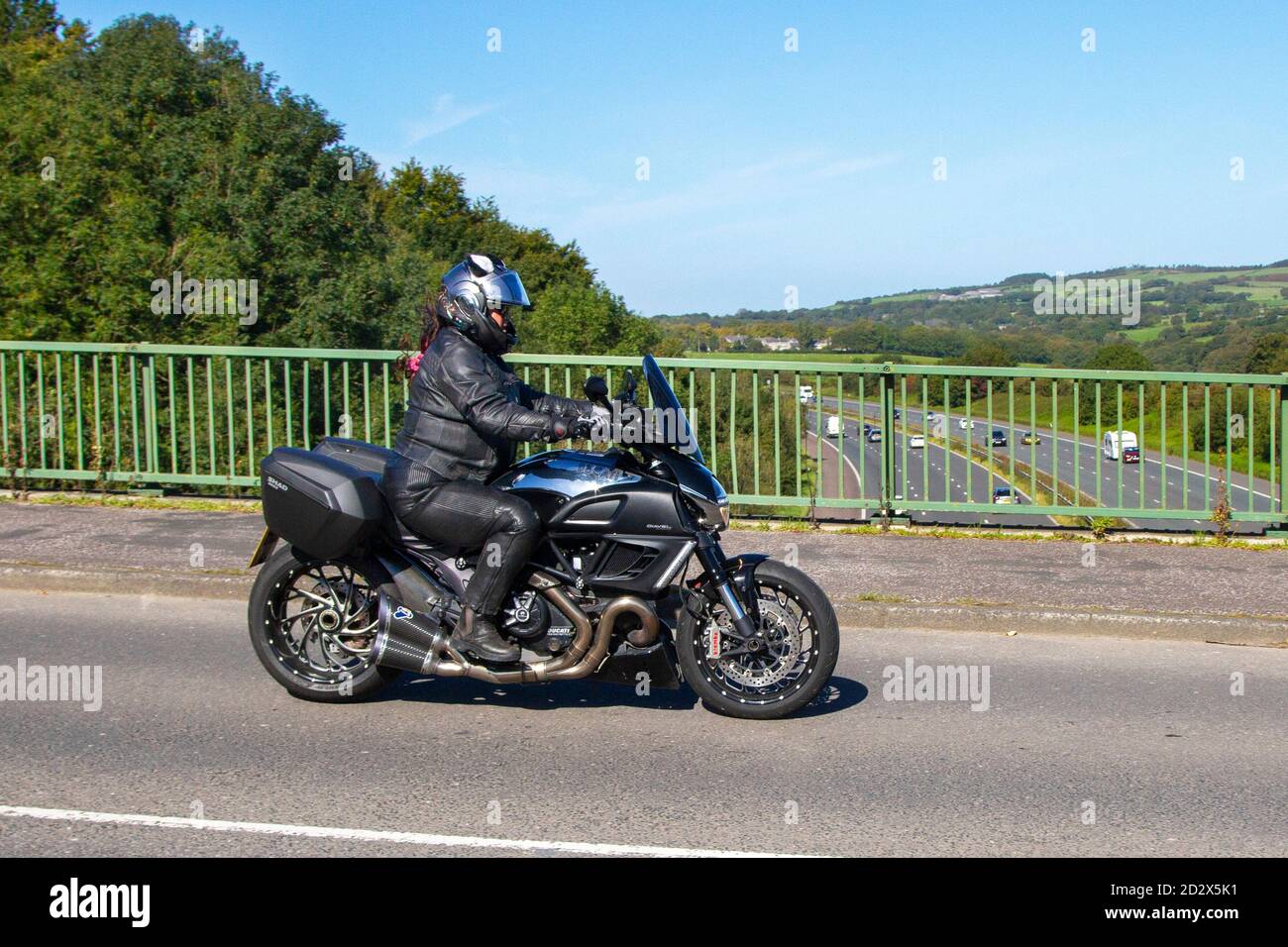 GK13UXP 2013 silver Ducati Diavel Cromo; Motorbike rider; two wheeled transport, motorcycles, vehicle, roads, motorbikes, bike riders motoring in Chorley, UK Stock Photo