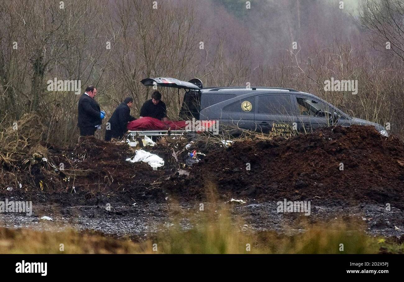 A body is removed by funeral directors in a area of bogland at Annaghgortagh on the Athlone to Mullingar road, about 3km outside the town, where the remains of Marie Greene was found. Stock Photo