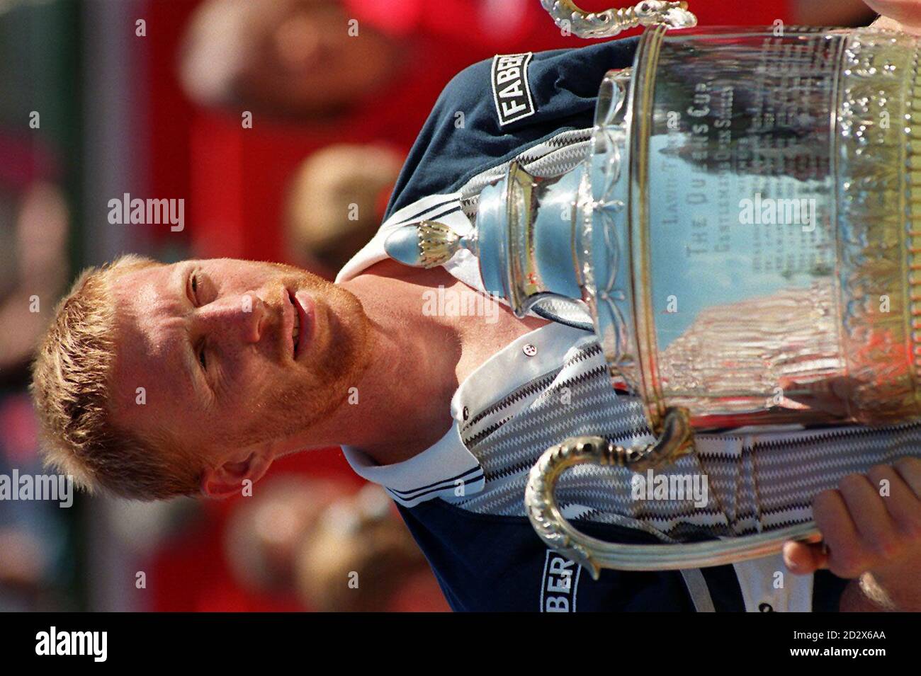 Germany's Boris Becker (D.O.B. 22/11/67) with the Stella Artois Trophy after defeating Sweden's Stefan Edberg in the final of the Grass Court Championships at The Queens Club today (Sunday). Photo by Neil Munns/PA Stock Photo