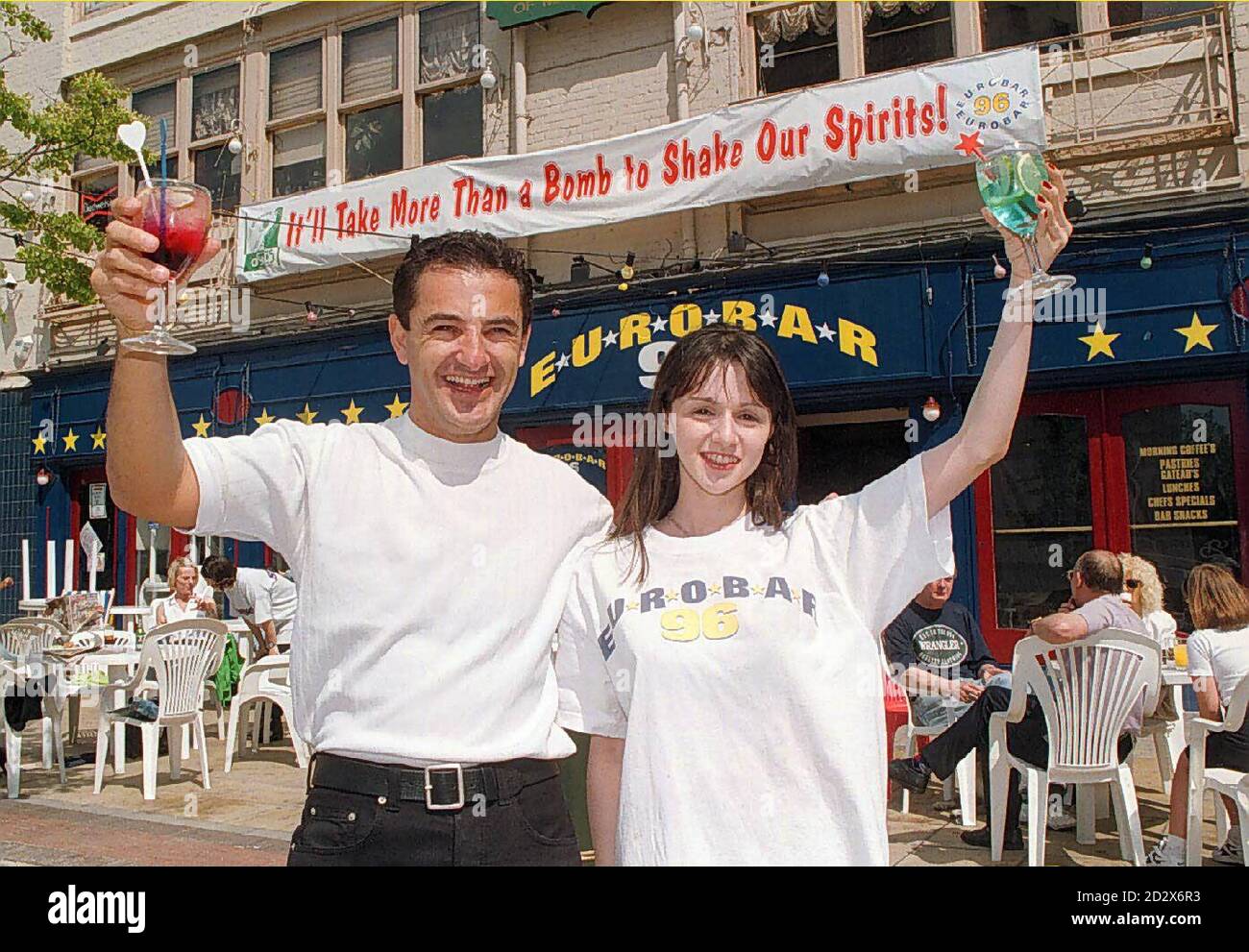 Bar owner Lloyd Sternberg and barmaid Athena Caramitsoni send a message to terrorists during today's (Sunday) Fun Day in Manchester's Albert Square. The city organised a weekend of music and entertainment to restore public confidence after last week's IRA bomb blast. See PA story BLAST Manchester. Photo by Brian Williamson/PA Stock Photo