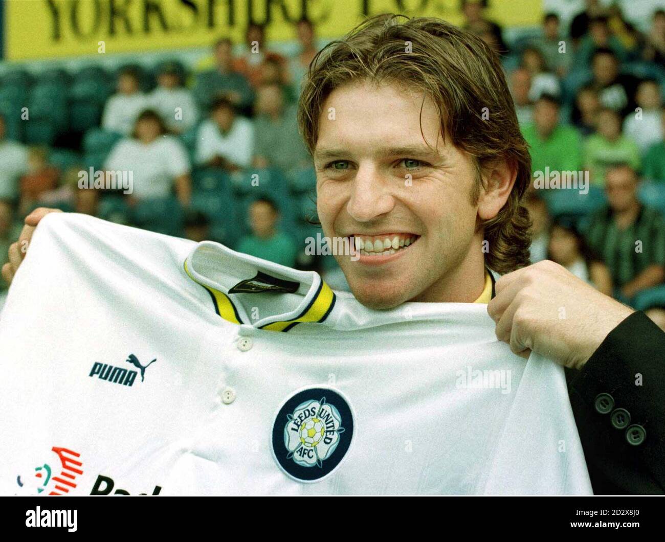 Former Manchester United player Lee Sharpe holds up his new Leeds United  shirt after signing a  million contract in front of several hundred fans  at Elland Road. See PA Story SOCER