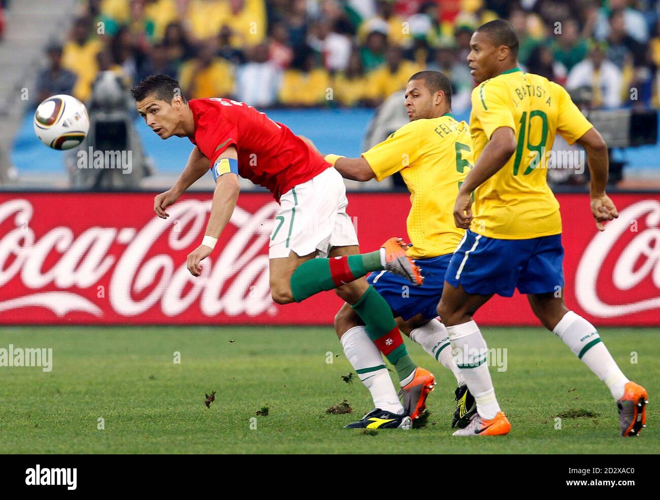 Portugal's Cristiano Ronaldo (L) fights for the ball with Brazil's Julio  Baptista (R) and Felipe Melo during a 2010 World Cup Group G soccer match  at Moses Mabhida stadium in Durban June