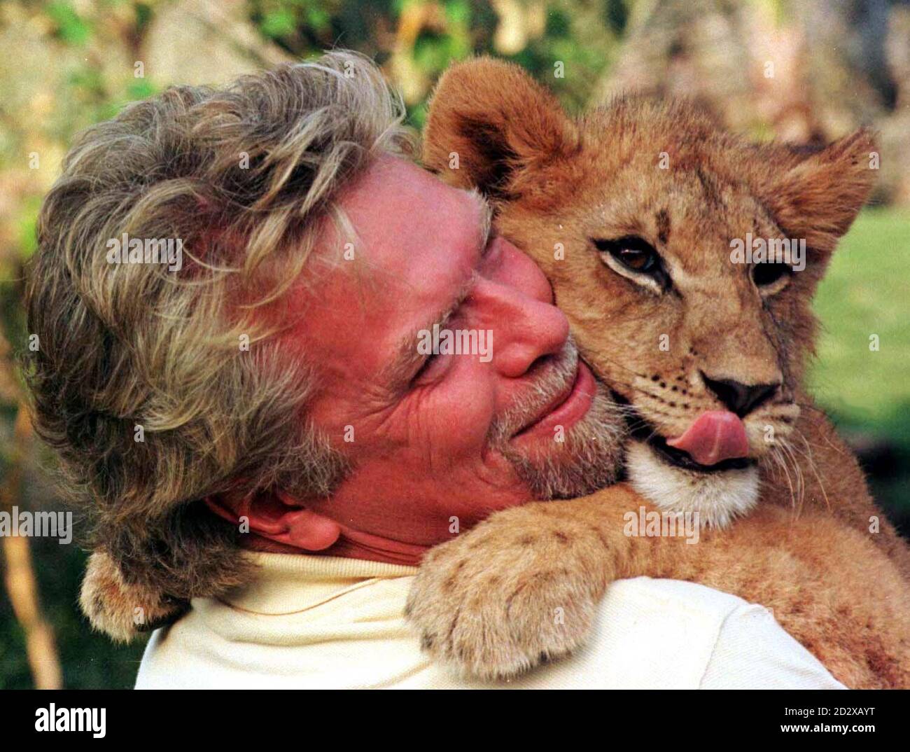 Virgin boss Richard Branson cuddles a young lion cub at Sun City in South Africa after ariving on his  inaugural flight to Johannesburg, South Africa, last Thursday. Photo by Adam Butler/PA. Stock Photo