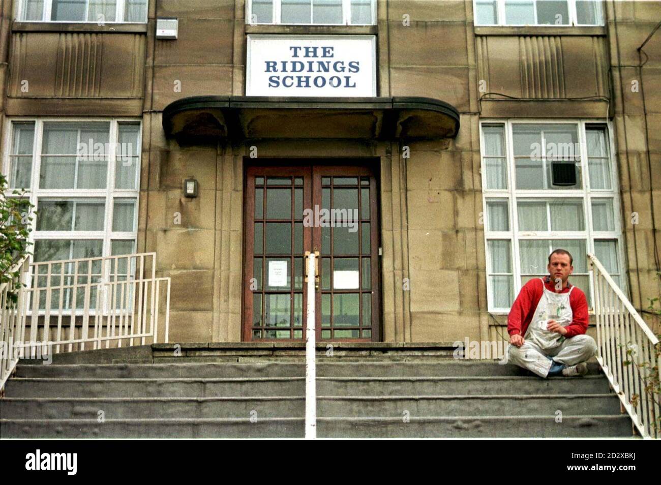 An unidentified decorator pauses in his work outside the main entrance of Ridings School, Halifax, during half-term today (Tuesday). Teachers there are threatening industrial action over their demand that 60 children - 1 in 10 of the pupils - should be expelled from the school beacause of their disruptive behavior. See PA Story EDUCATION Expel/Photo by Paul Barker/PA Stock Photo