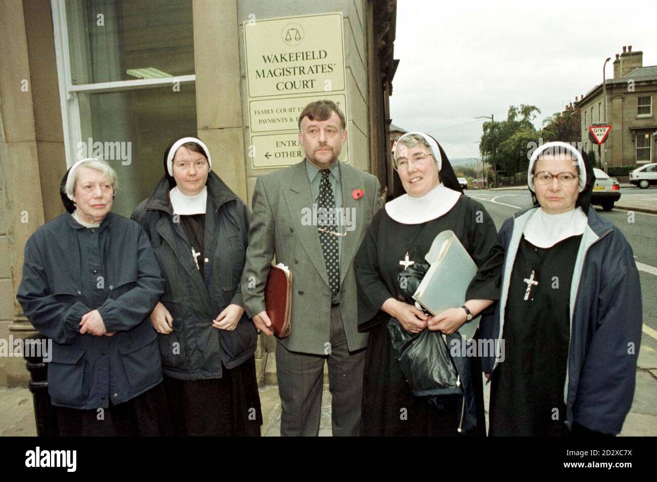 l to r Sister Mary Claire, Sister Gwyneth Mary, M.P. John Hinchcliffe, Mother Rabina and Sister Elizabeth outside Wakefield Magistrates Court where they are trying to prevent the granting of a licence to sell alcohol on the site of their former convent in Horbury, Wakefield, west Yorkshire. The court battle is the latest stage of a war which began after the Sisters of the Community of St Peter sold the dilapidated St Peter's Convent in Horbury, Wakefield, west Yorkshire, to developer John Kirby in 1993. The nuns, who moved into a nearby building, believed the convent would be used by a Stock Photo