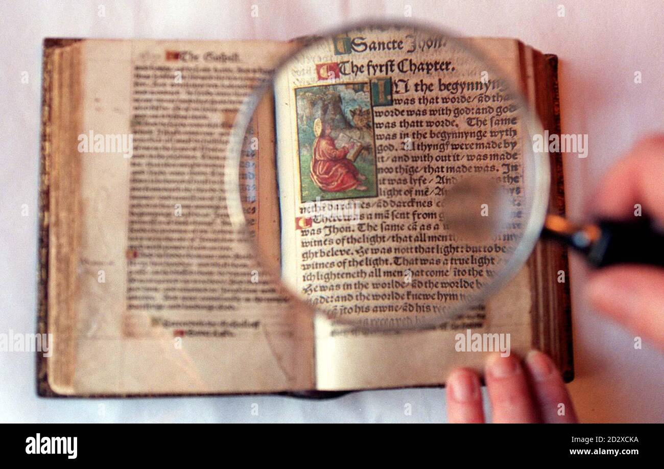 06/10/1536 - On this Day in History - William Tyndale, who was the first man ever to translate the Bible into English, was executed under the orders of King Henry VIII  A magnifying glass highlights the precise script and illustrations in the only complete extant copy of the 1526 edition of William Tyndale's translation of the New Testament, the first ever printed in English from original sources. The edition, bought recently by the British Library for $1.5 million, will be the centrepiece of a new exhibition 'Let There Be Light - William Tyndale and the Making of the English Bible' set to tou Stock Photo