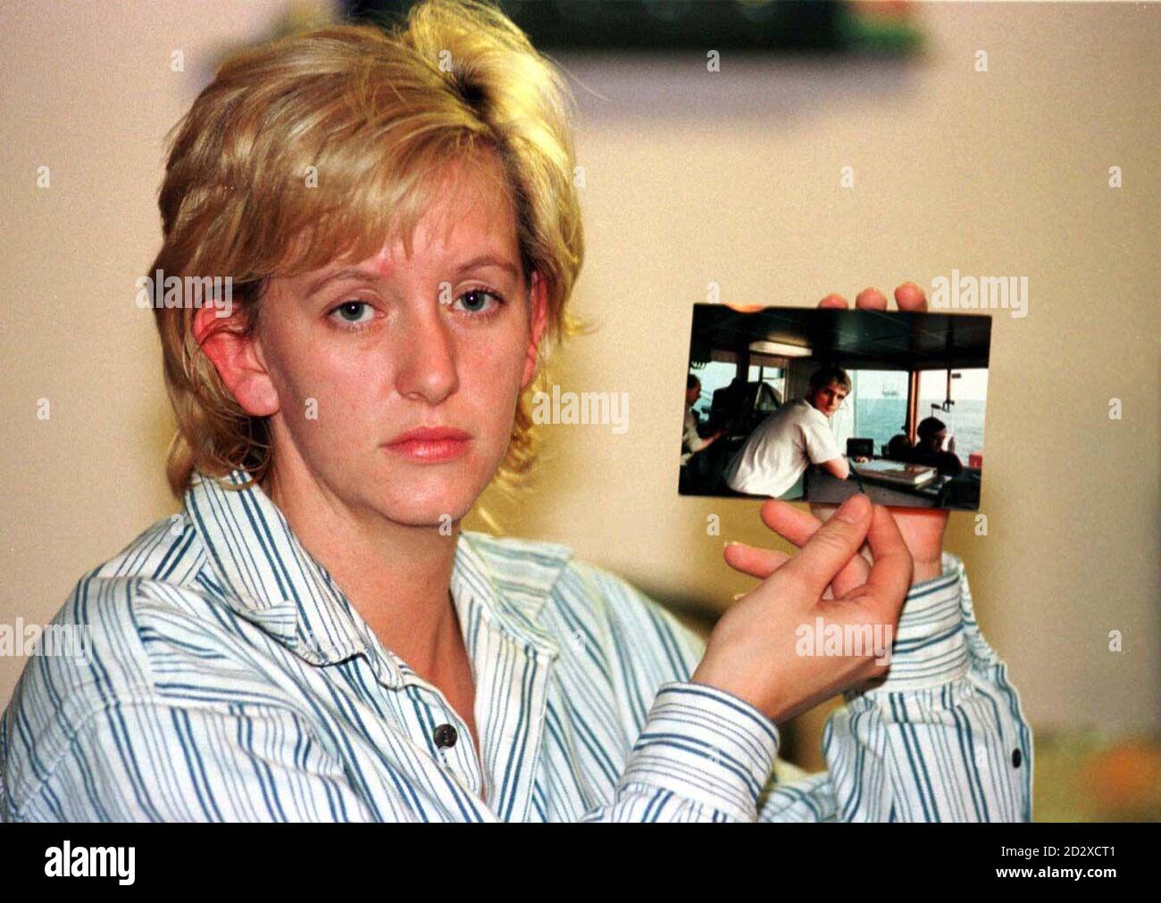 Julie Godfrey the girlfriend of the first Briton, Stephen Shuckford, known to have been on the airliner that crashed in Nigeria, killing all 141 people on board, holds a picture of Stephen. See PA Story AIR Nigeria. PA Photos. Stock Photo