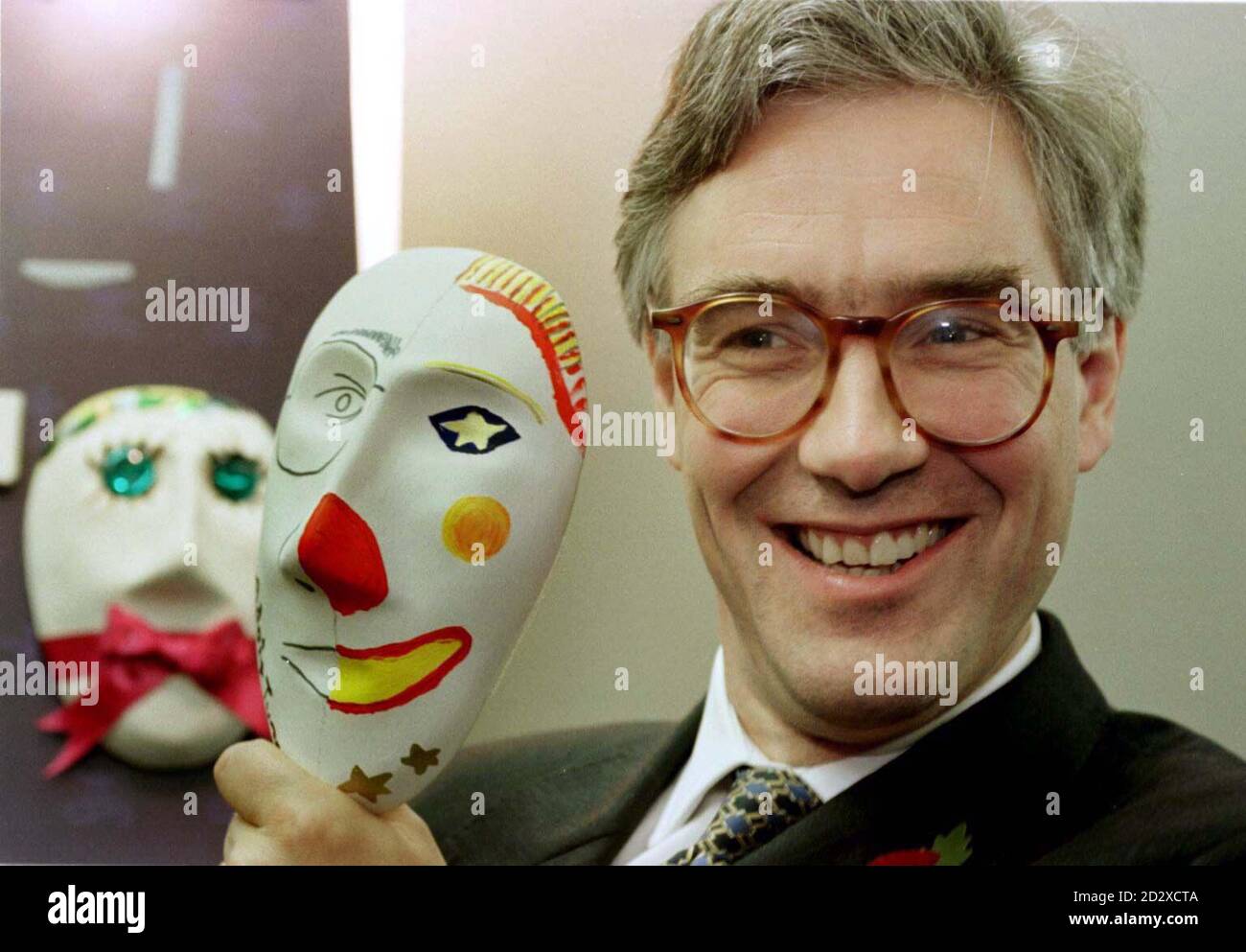 Confederation of British Industry Director General Adair Turner poses for photos by the mask he designed in support of The Prince's Trust charity on the eve of the CBI conference in Harrogate today (Sunday). The mask, one of some 250 all painted by celebrities, will be auctioned later this year. See PA Story CBI Conference/ Pic: Bob Collier/PA. Stock Photo