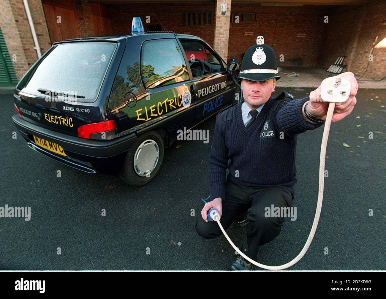 Fill 'er up!!. PC Rob Piper puts his new electric car on a 'charge' at  Kidderminster Police station. The battery powered car has a top speed of 56  mph has a range