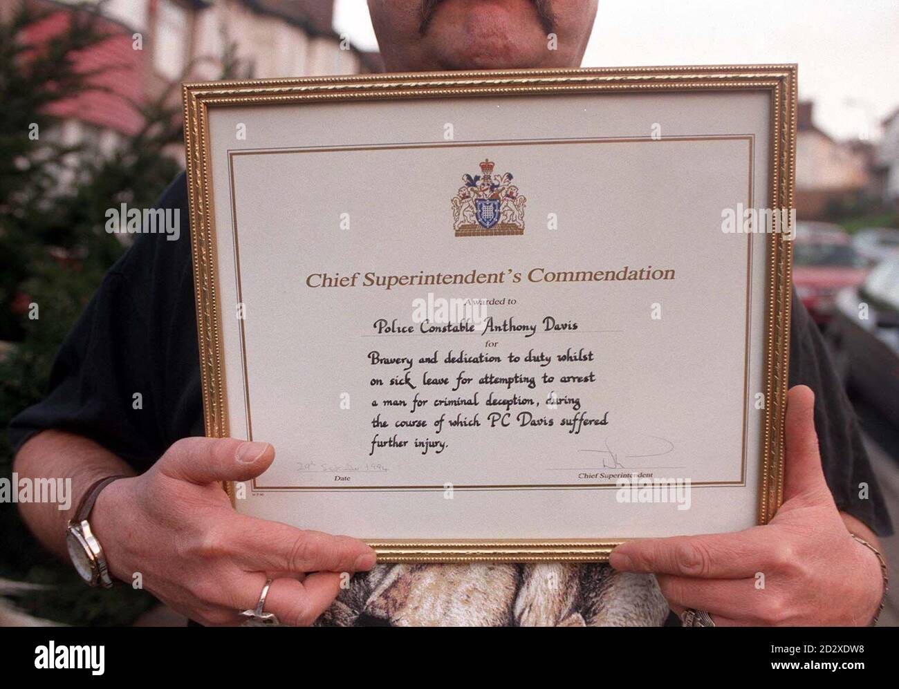Former police officer Anthony Davis holds a commendation certificate from the Metropolitan Police Chief Superintendent, given for bravery and dedication to duty. Animal-lover Mr Davis, who has five dogs, three cockatoos, two rabbits and a pigeon, was forced to resign from the police force after taking home a lost dog. See PA story POLICE Dog. Photo by Michael Stephens/PA Stock Photo