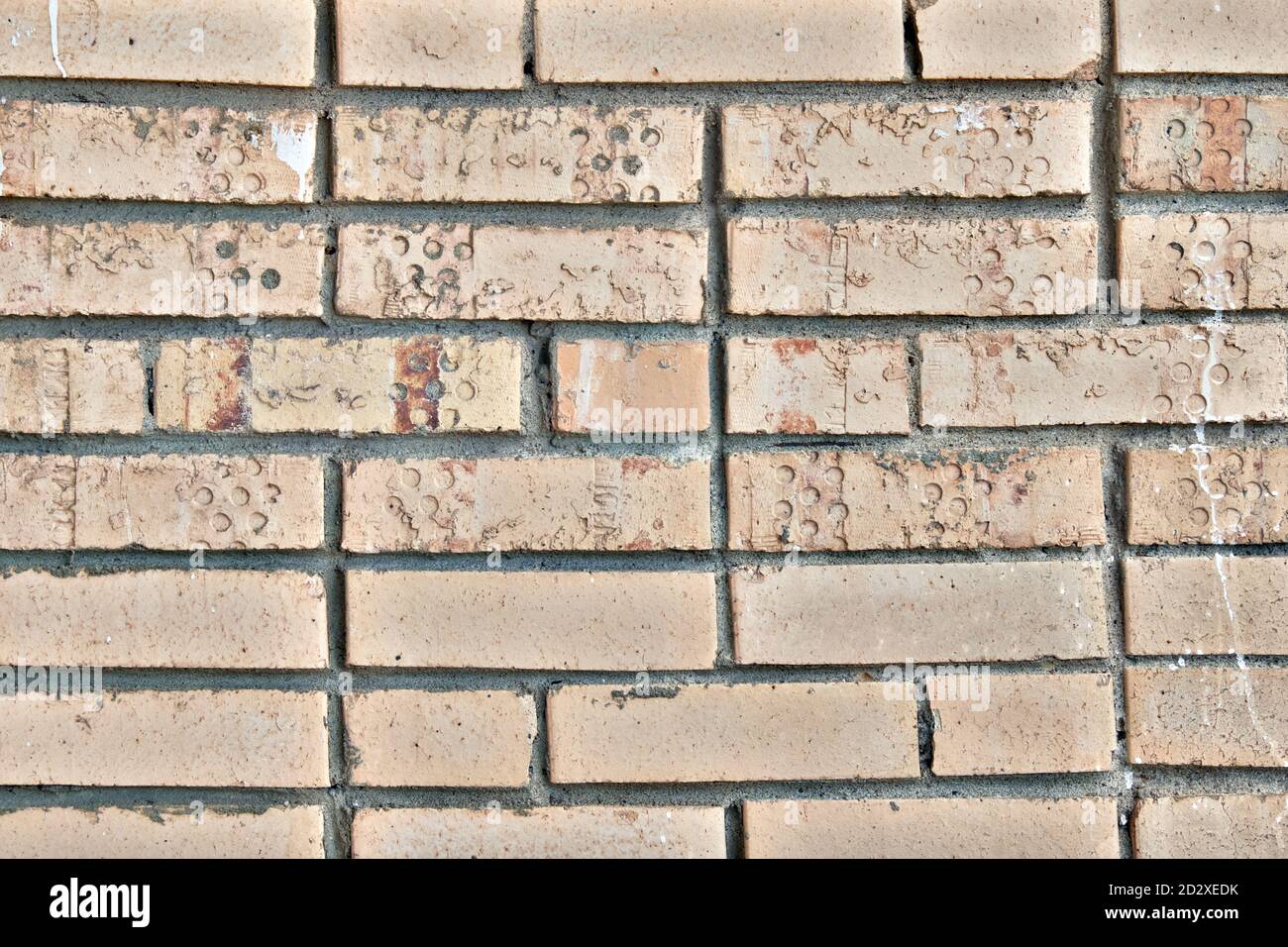 The texture of old broken bricks. Dirty brick walls from damage and smeared with paint. Traces