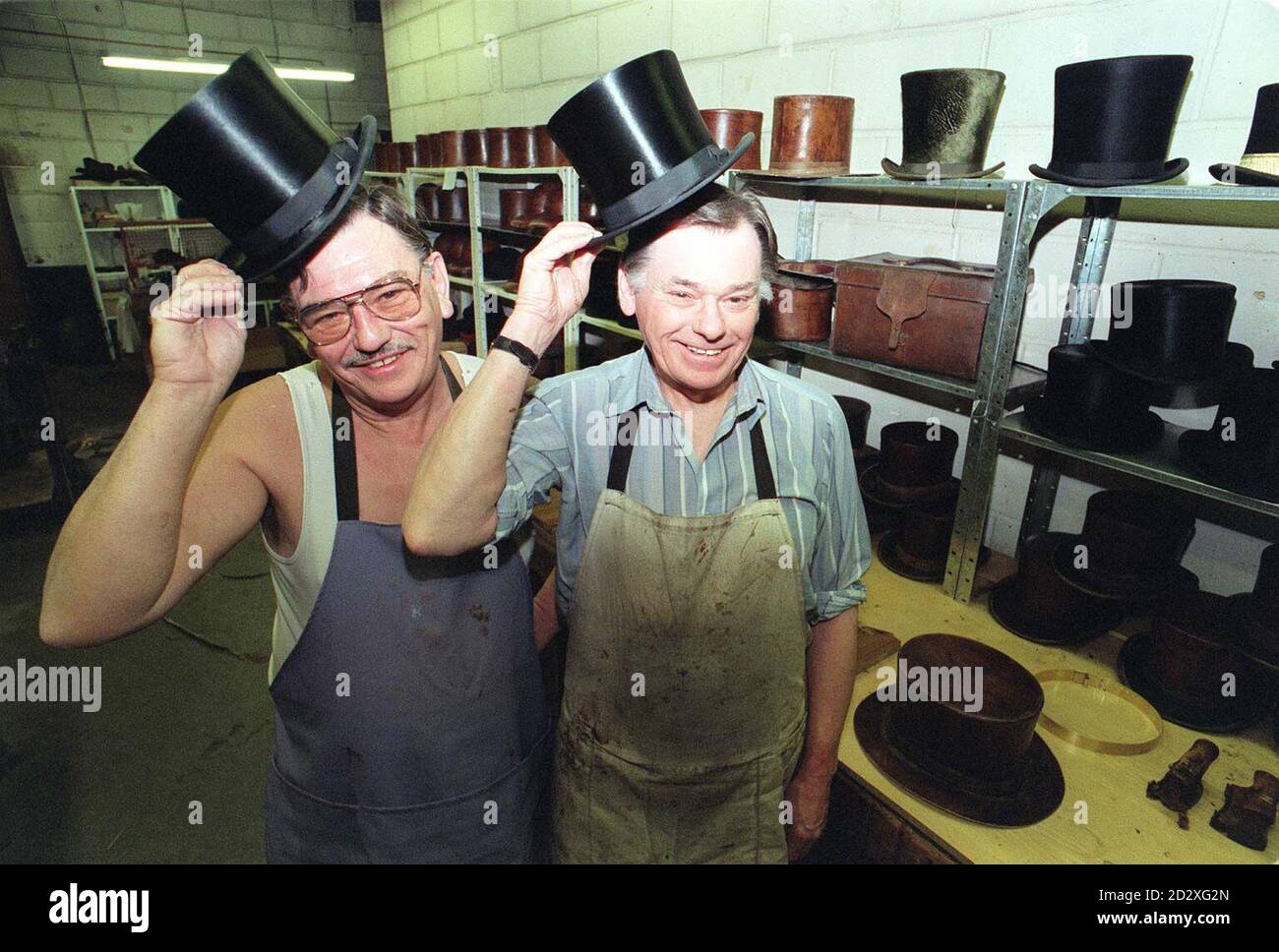 Top hat makers, brothers Ray (left) and Derek Corn, at their workshop in Amelia Street, London. The Top Hat is 200 years old on Monday, Jan 13. It was first worn by John Hetherington, a hat-maker in the Strand, who was arrested, and charged with causing a breach of the peace by wearing a tall structure having a shiny lustre calculated to alarm timid people. He was bound over in the sum of  500 - equivalent of  13,500 in today's money - not to repeat the offence.  Photo by Rebecca Naden. See PA Story CONSUMER Top Hat. Stock Photo