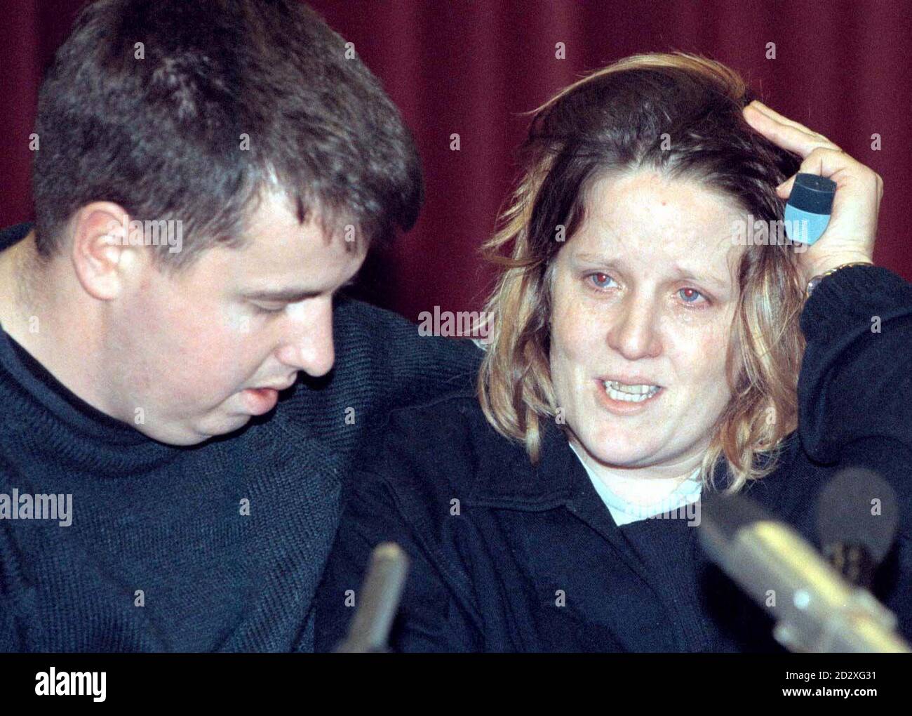 Paula Evans, mother of missing girl Zoe Evans, clutches an  asthma inhaler as she is comforted by (her husband and Zoe's stepfather) Miles Evans during a  press conference at Warminster today (Monday). The nine-year-old has been missing for two days. See PA story MISSING Zoe. Photo by Barry Batchelor/PA Stock Photo