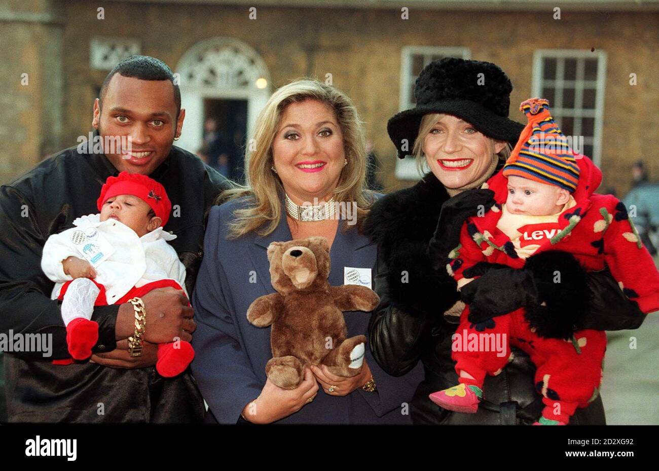 (l/r) Gladiator Rhino (Mark Smith) and his daughter Chloe, TV presenter Vanessa Feltz and former EastEnders star Michelle Collins and her daughter Maia, launch the Tommy's Campaign and Huggies 1997 Parent Friendly Awards in London today (Thursday). Two million voting forms will be available through retail and leisure outlets nationwide from today, asking parents to vote for those shops, restaurants and leisure organisations which provide the most genuinely parent friendly facilities. Voting ends on February 14, 1997 and the winners of the 1997 Parent Friendly Awards will be announced on Thursd Stock Photo