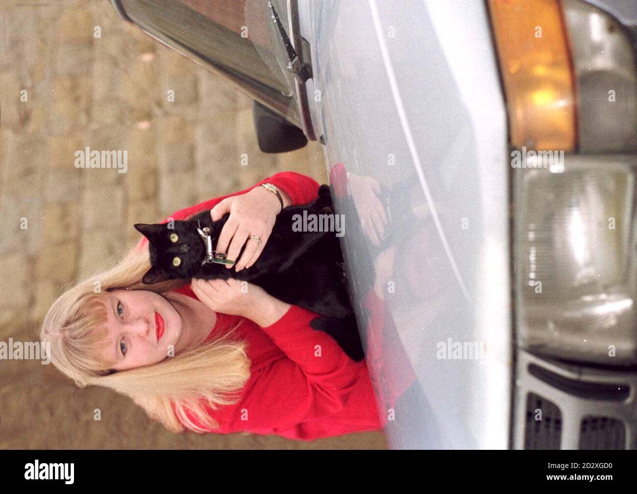 26 year-old Sharon Snowden is delighted to have her cat Magic back, who vanished last Monday from his home in Rodley, west Leeds, after contractors had been digging up the road for cable television in a nearby street. The inquisitive feline had climbed up under the wheel arch of the contractors transit van and made himself comfortable in a padded space in the engine near the water heater. The contractors, not realising they had a passenger in their engine, drove back and forth from Leeds to Barnsley, which is forty miles away, over a three day period, covering 160 miles, before they opened t Stock Photo